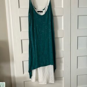 Cut-loose spaghetti strap, midi slit dress with an asymmetrical hanky hem.